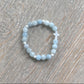 White Cross & Aquamarine Beaded Bracelet The Cole Collection