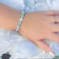 White Cross & Aquamarine Beaded Bracelet The Cole Collection